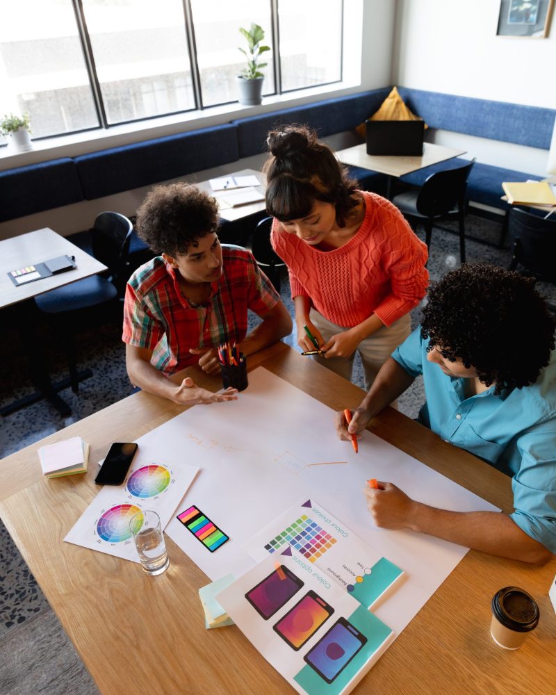 Creative multiracial male and female colleagues discussing business plan in office. Unaltered, teamwork, creative business, workplace, diversity, design occupation.